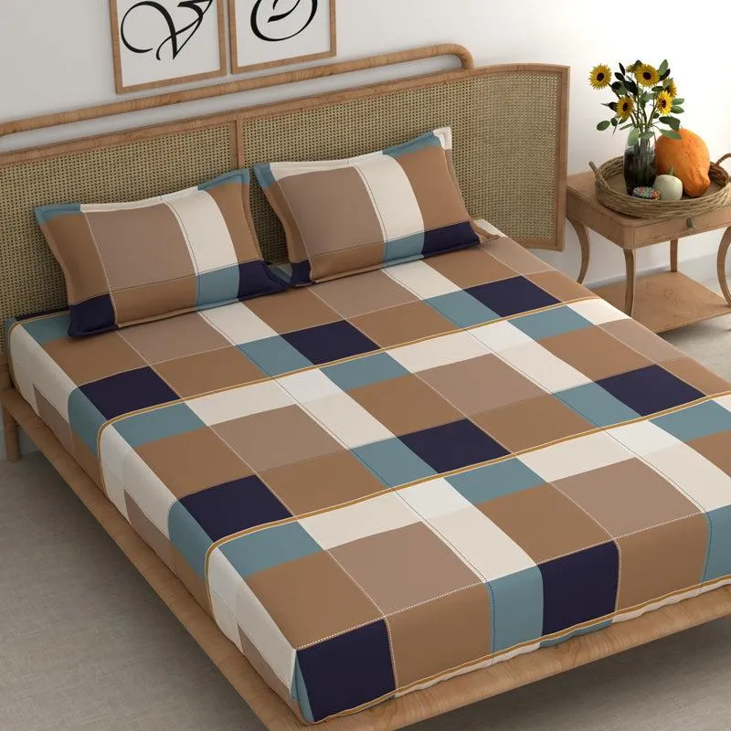 Brown, cream and blue check bedsheet with two matching pillow covers on a bed
