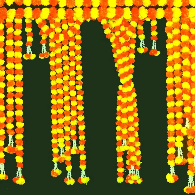 Orange and yellow floral toran strands hanging in a row