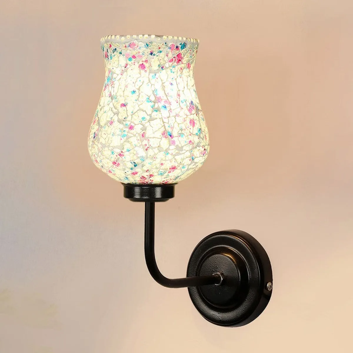 Front angled view of lit blue mosaic glass wall lamp