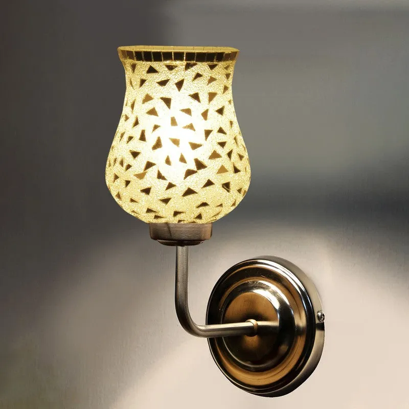 Lit silver mosaic wall lamp casting soft light on wall