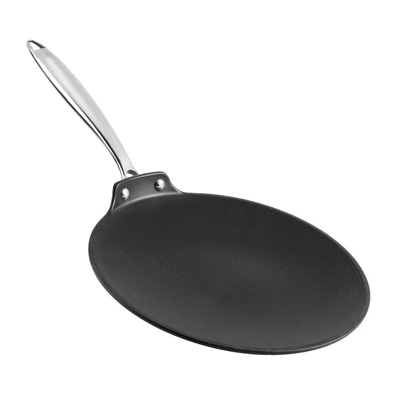 Black cast iron roti tawa shown at an angle against a white background