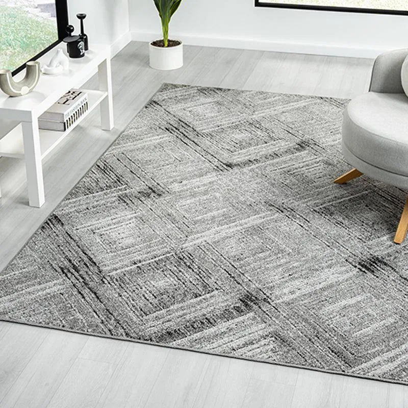 Grey rectangular carpet with a geometric pattern styled in a bright living room