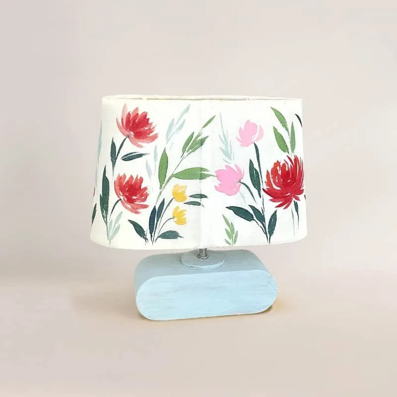 Multicolour floral table lamp with a light blue base, front view