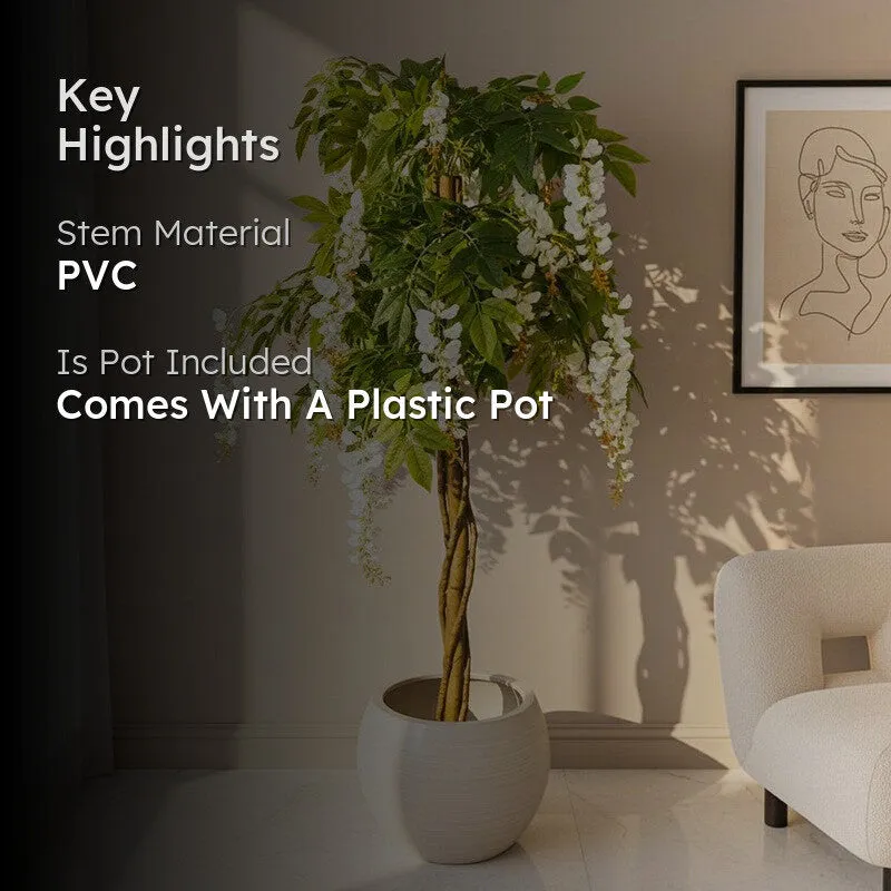 Artificial flowering plant displayed in a bright room beside framed wall art
