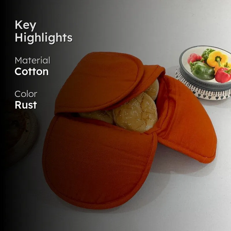 Rust bread basket with bread rolls and cotton material highlight