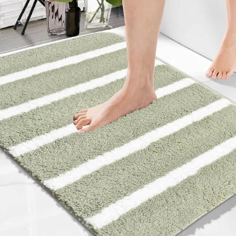 Close-up of a green and white striped bath mat with a soft textured surface