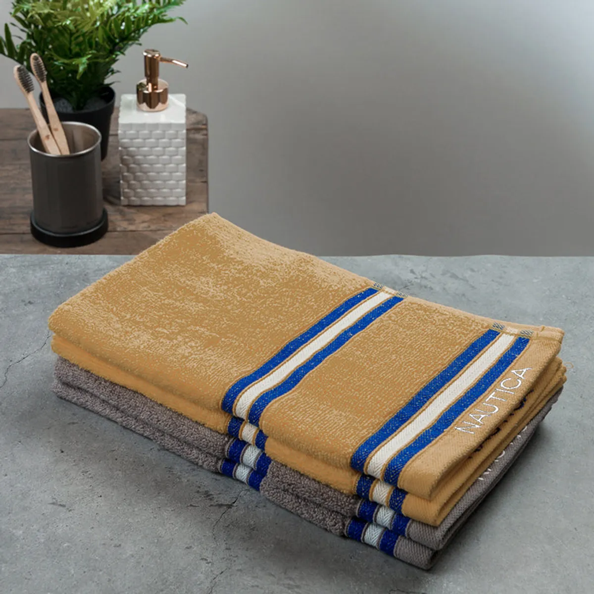 Four folded yellow and grey striped hand towels