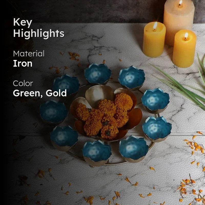 Blue and gold urli displayed with flowers and candles