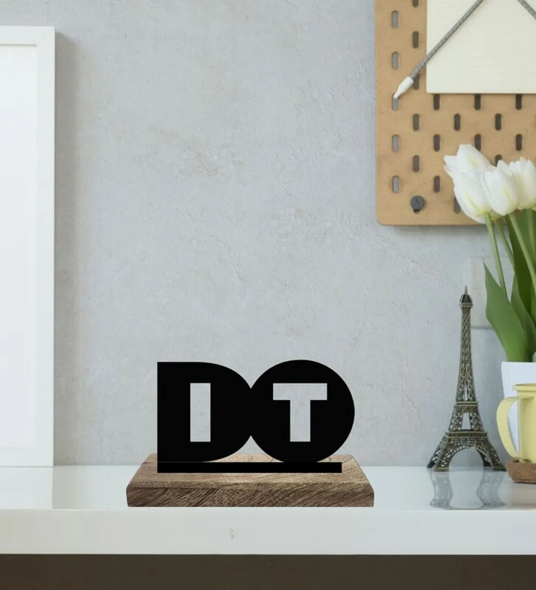 Black DO IT typography showpiece on a wooden base