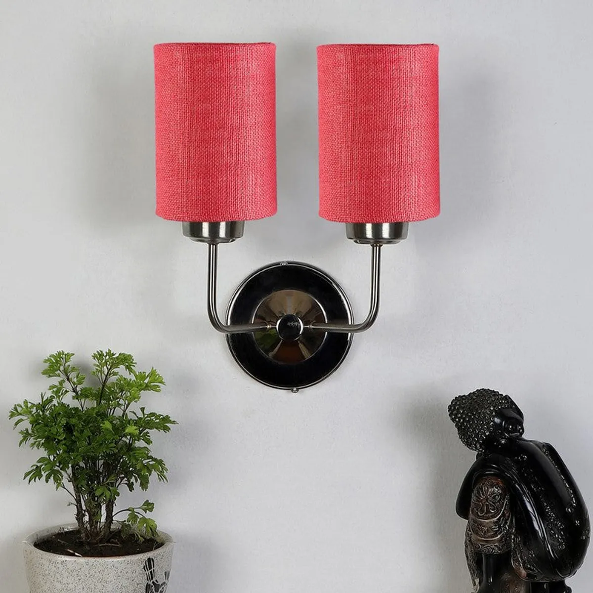 Red jute double-shade wall lamp on a white wall