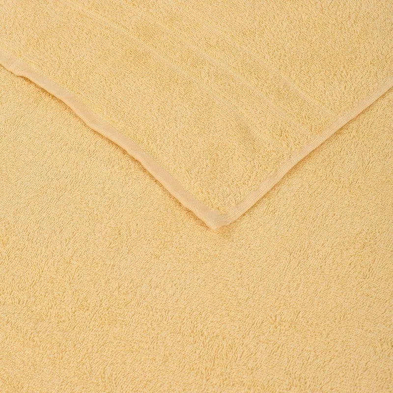Close-up view of the yellow towel's plush textured surface and border