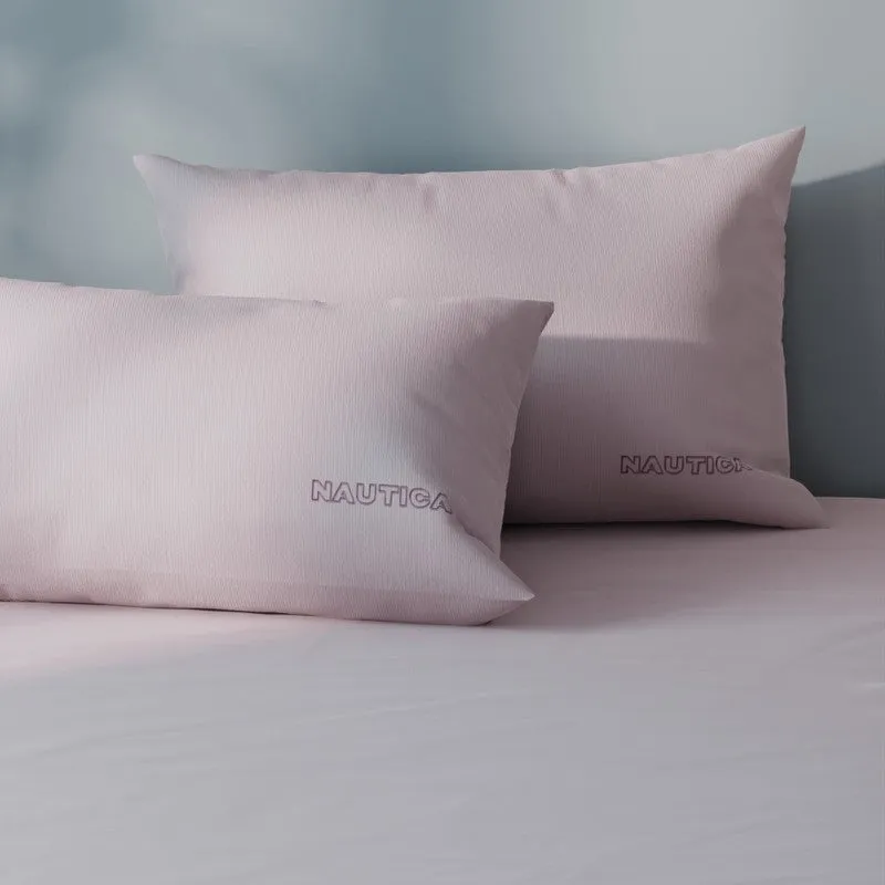 Close-up of pink cotton pillow covers with Nautica branding