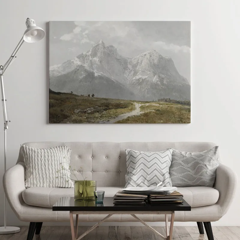 Rectangular mountain landscape wall art displayed above a light sofa