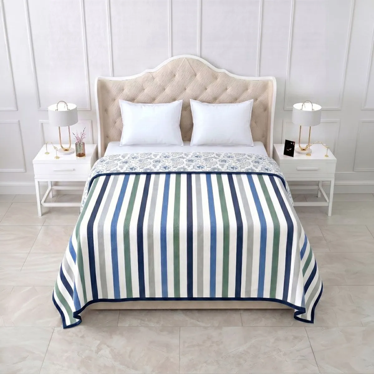 Reversible dohar spread on a bed with blue striped side facing up