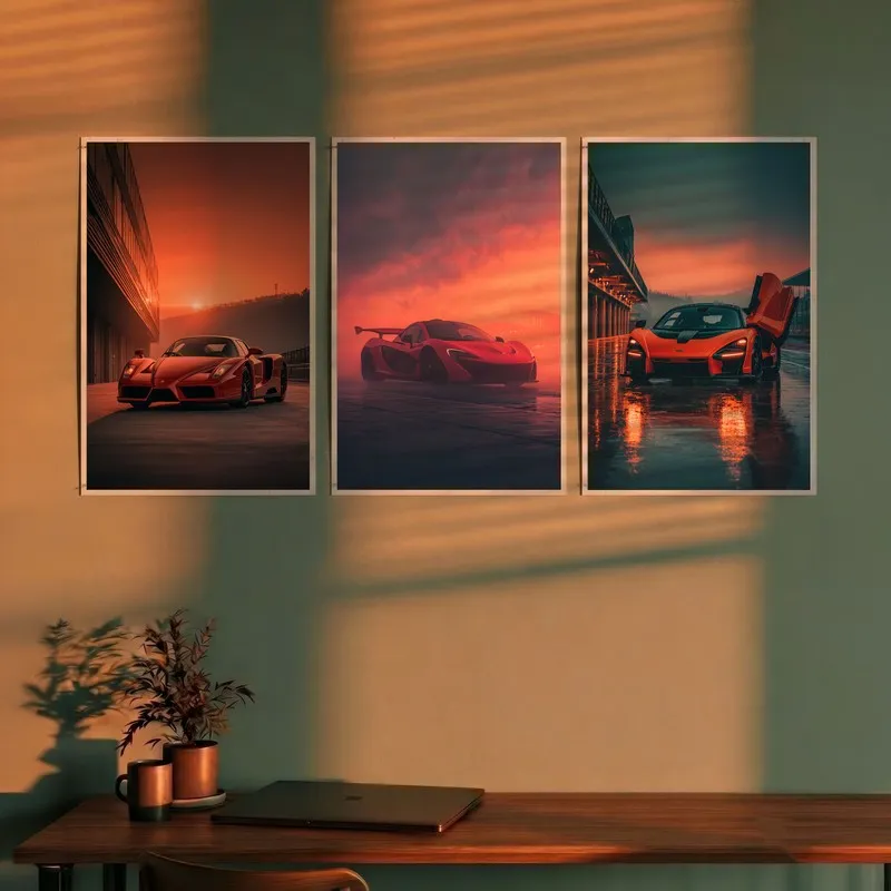Set of three car wall posters above a desk in warm sunset lighting