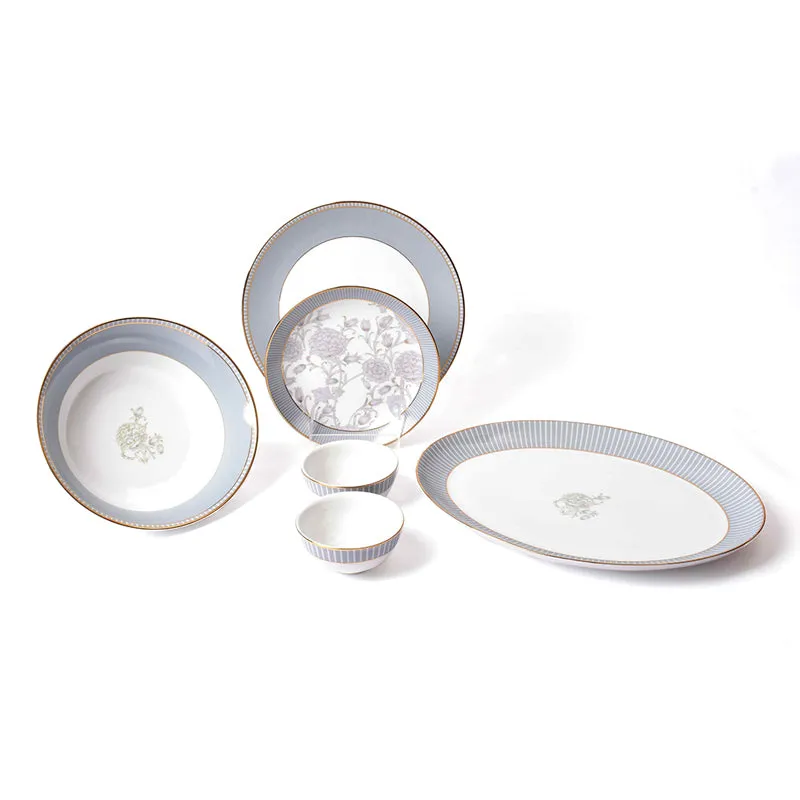 Grey porcelain dinner set with floral details, gold rims, plates, bowls and an oval platter