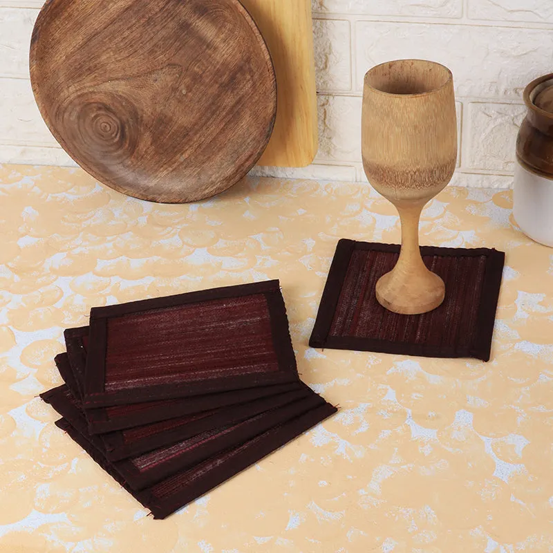 Set of brown square coasters styled on a tabletop with wooden decor