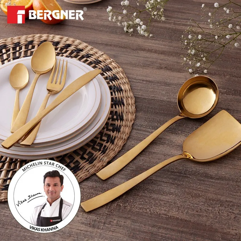 Gold cutlery arranged on plates and a woven placemat