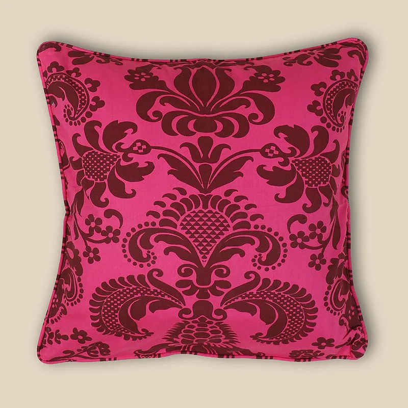 Single square pink cushion cover displaying an ornate brown floral design.