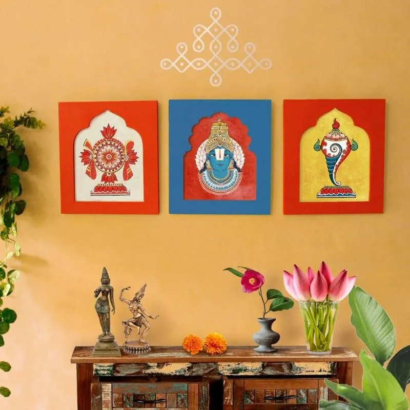 Three colourful spiritual wall accents styled above a console with plants and decor