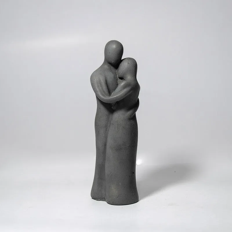 Angled view of a grey abstract figurine showpiece on a plain background
