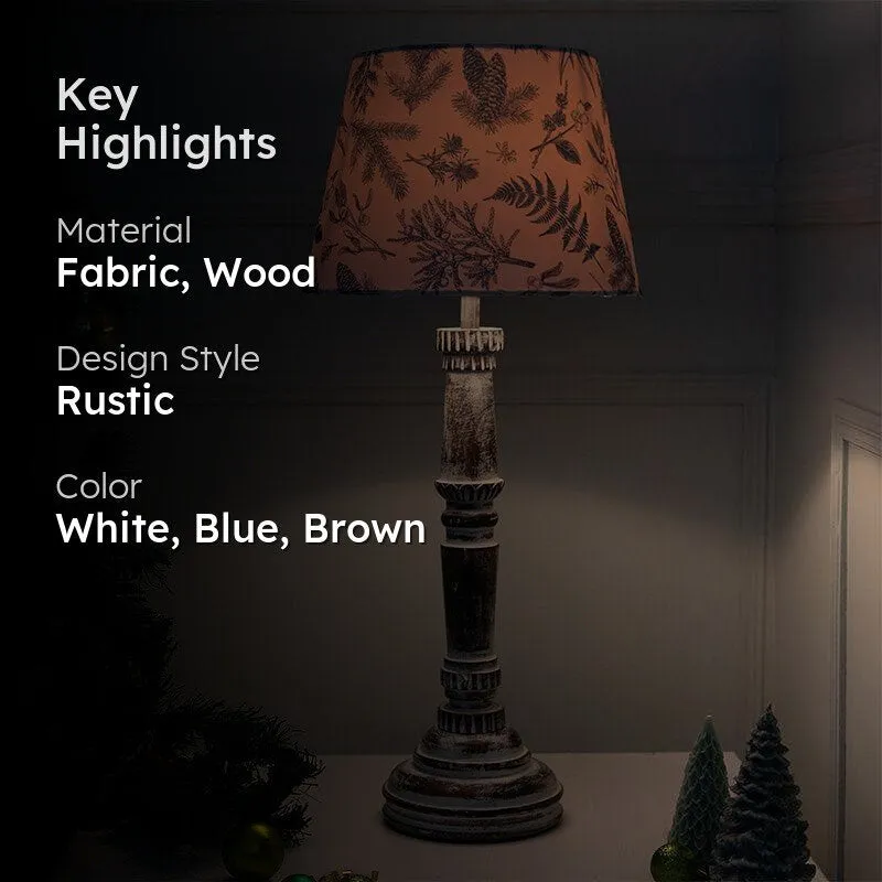 Lit table lamp with blue botanical shade and distressed wood base