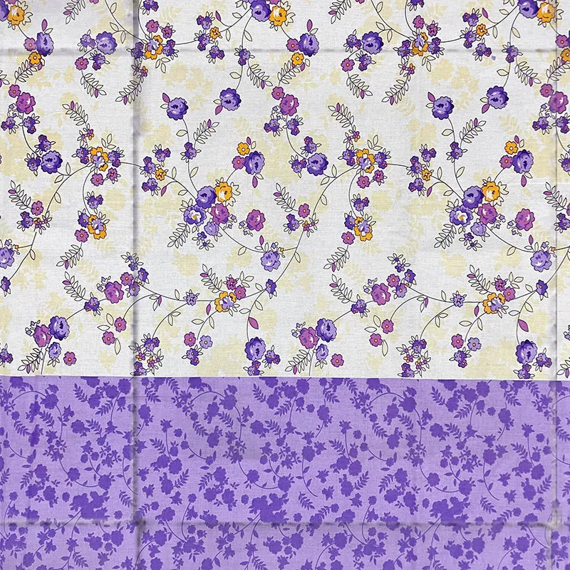 Close-up of purple and white floral comforter print and border