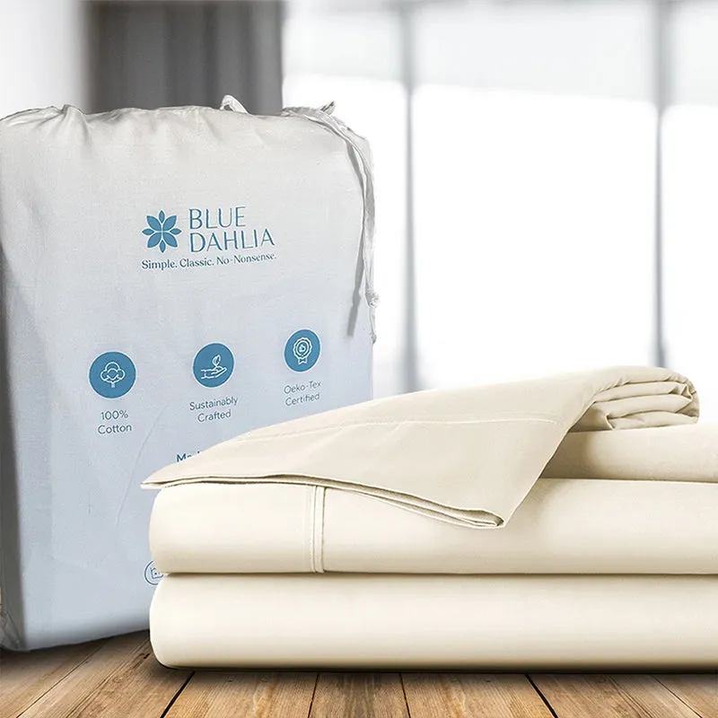 Folded ivory bedsheet and pillow cover placed beside a fabric storage bag