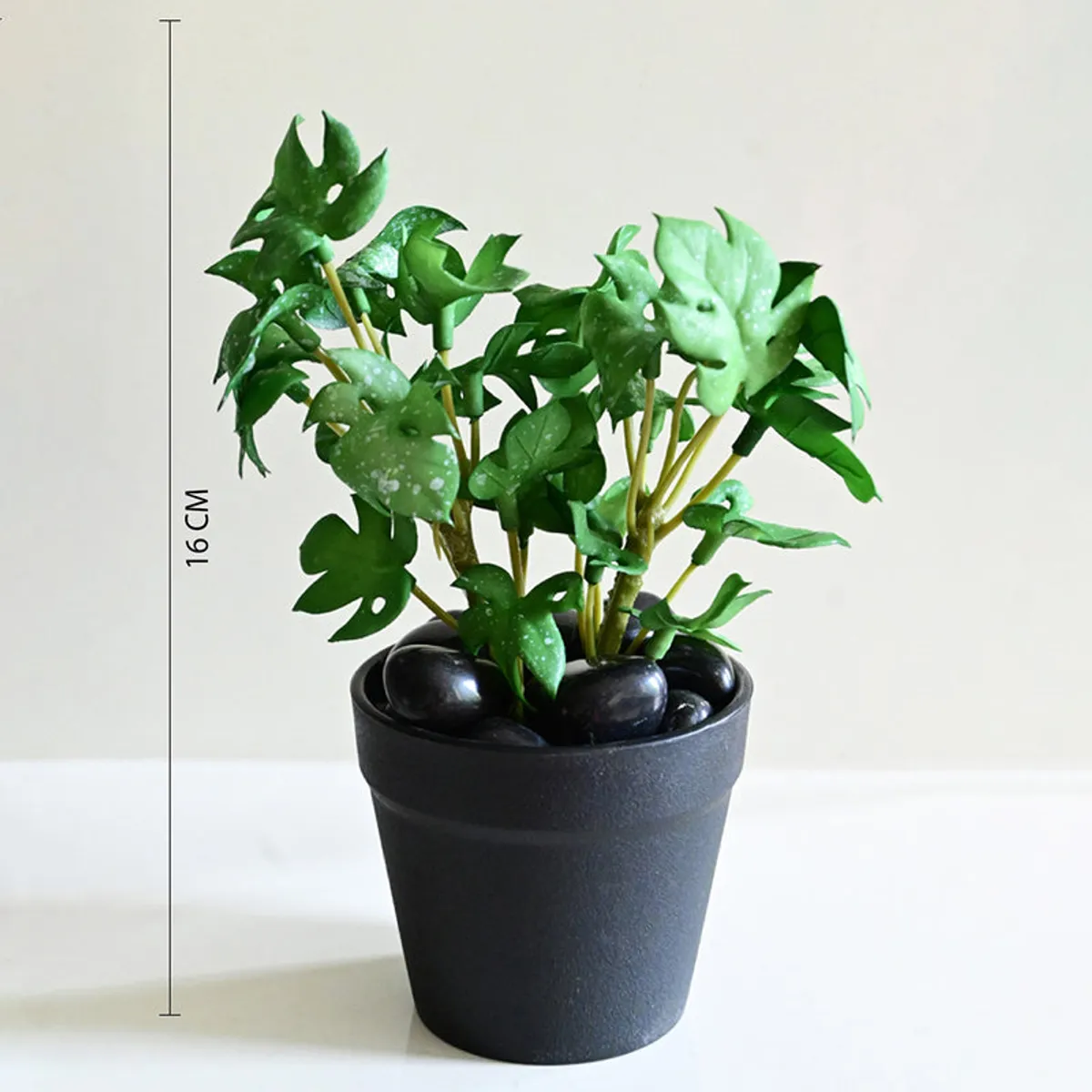 Artificial Monstera plant shown beside a height reference