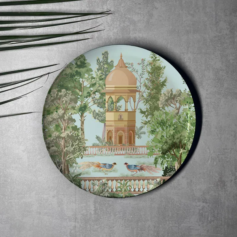 Round wall plate with pavilion, trees and birds in a garden setting
