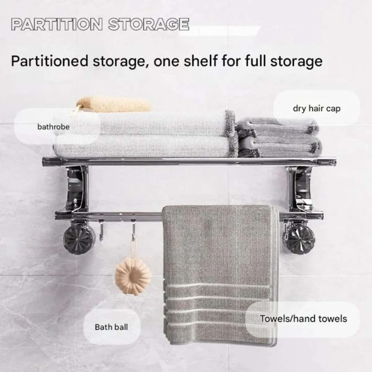 Front view of silver wall-mounted hanger with folded towels and hanging towel