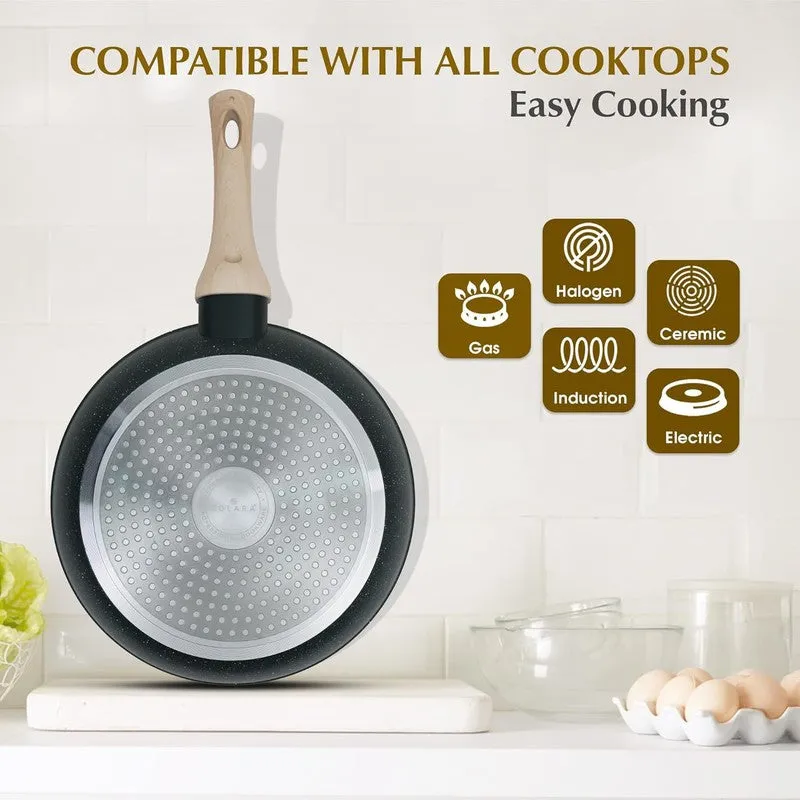 Underside of a black frying pan showing its cooktop-compatible base