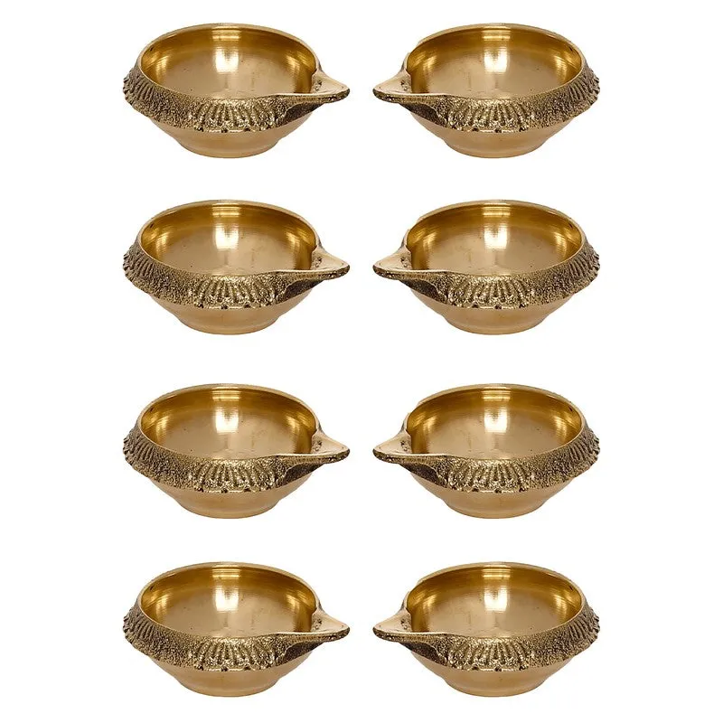 Eight gold brass diyas shown against a plain white background