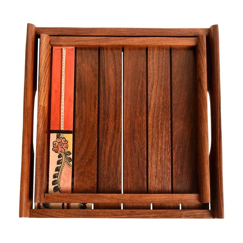Top view of two brown wooden trays with red decorative detailing