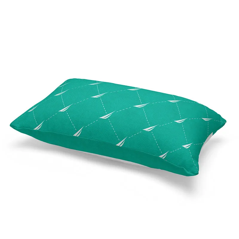 Reverse side of teal cushion cover featuring a repeating white sailboat pattern