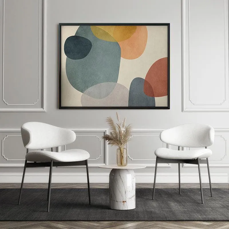 Black-framed abstract wall painting displayed above two white chairs in a panelled room