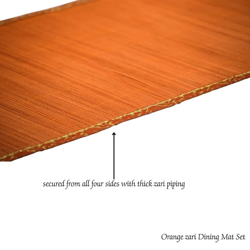 Detailed view of the orange runner with a decorative gold-toned edge