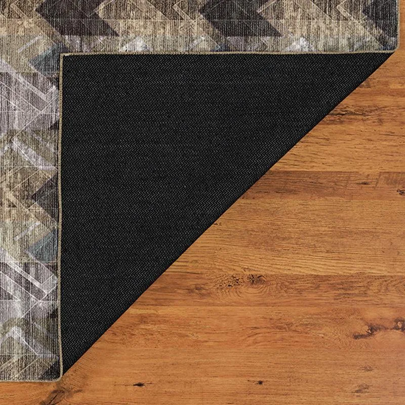 Underside corner of the carpet folded back on a wooden floor