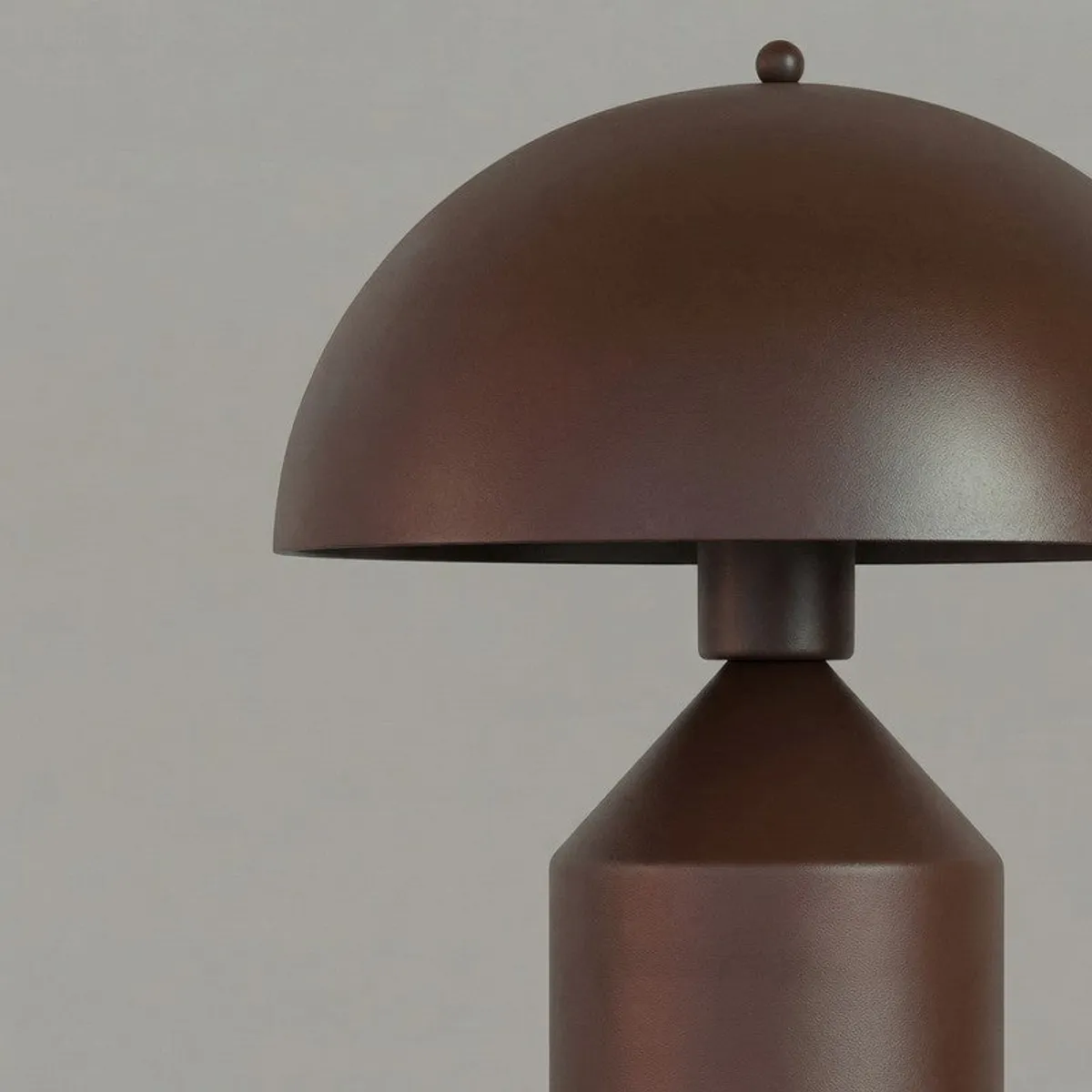 Close-up showing the brown matte dome shade and tapered lamp base