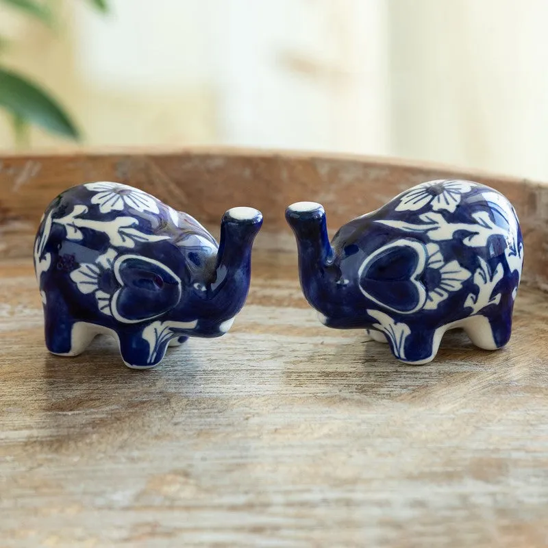 Pair of blue and white floral salt and pepper shakers on a wooden surface