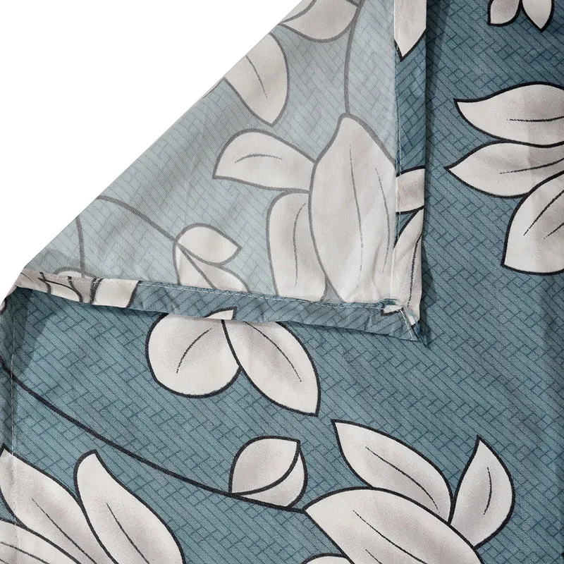 Detailed view of the floral table cover hem and blue printed fabric