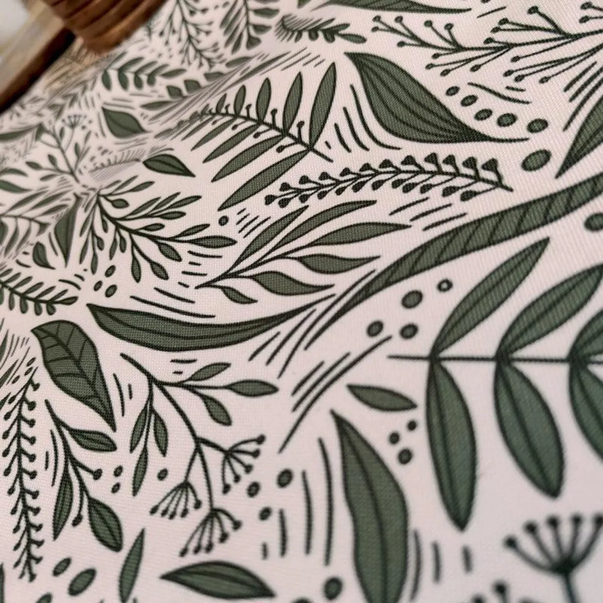Close-up view of the green leafy print on the table runner