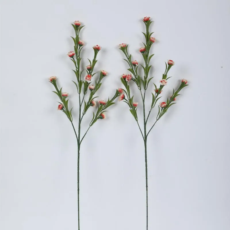 Two pink faux mini rose bloom stems against a plain background