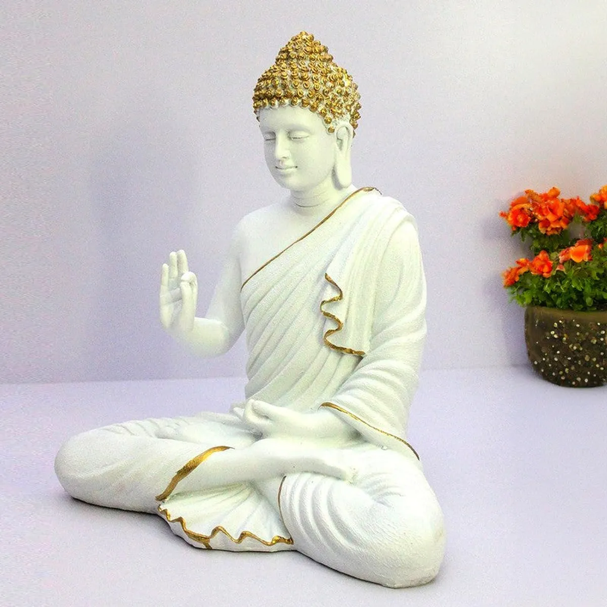 Side angle of white Buddha marble showpiece with gold accents