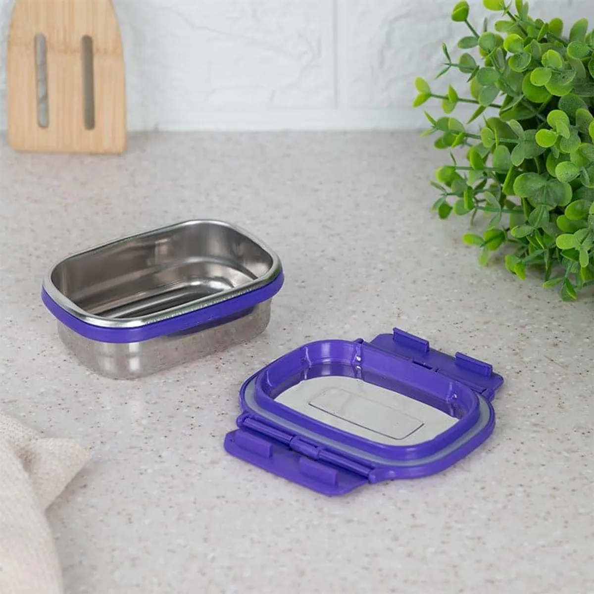 Purple lunch box base and lid displayed separately on a countertop