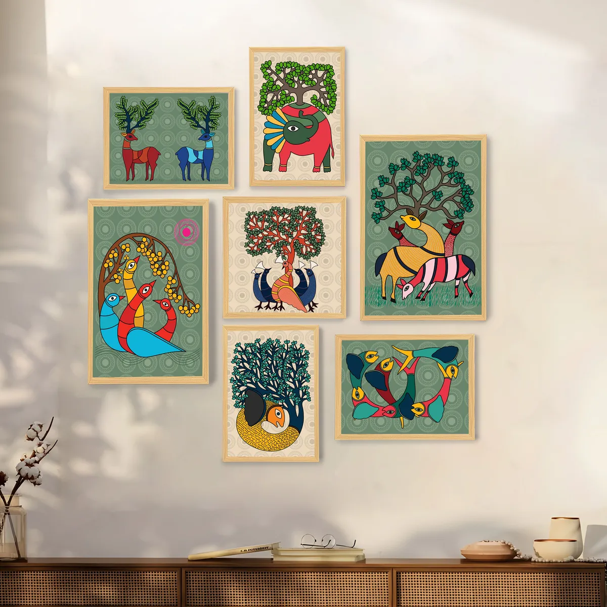 Seven framed art prints displayed on a sunlit wall above a sideboard.