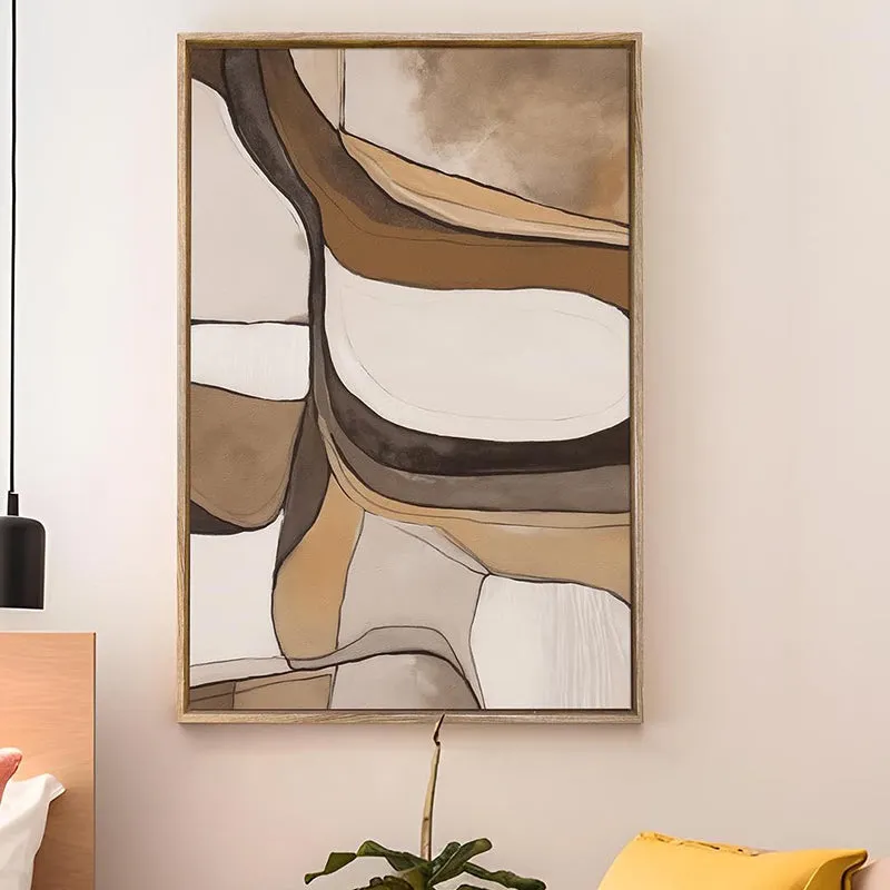 Framed abstract wall art in neutral tones displayed on a bedroom wall