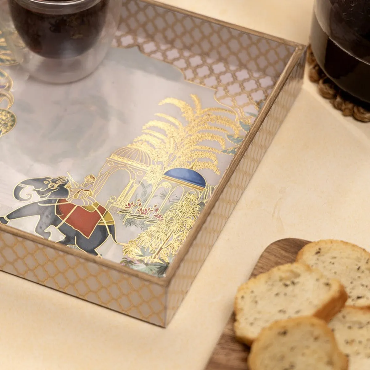 Close view of the tray featuring a blue elephant and gold botanical artwork