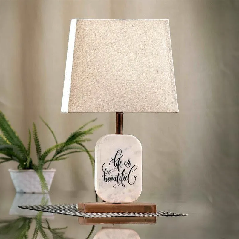 Table lamp with beige rectangular shade and white marble base on tabletop