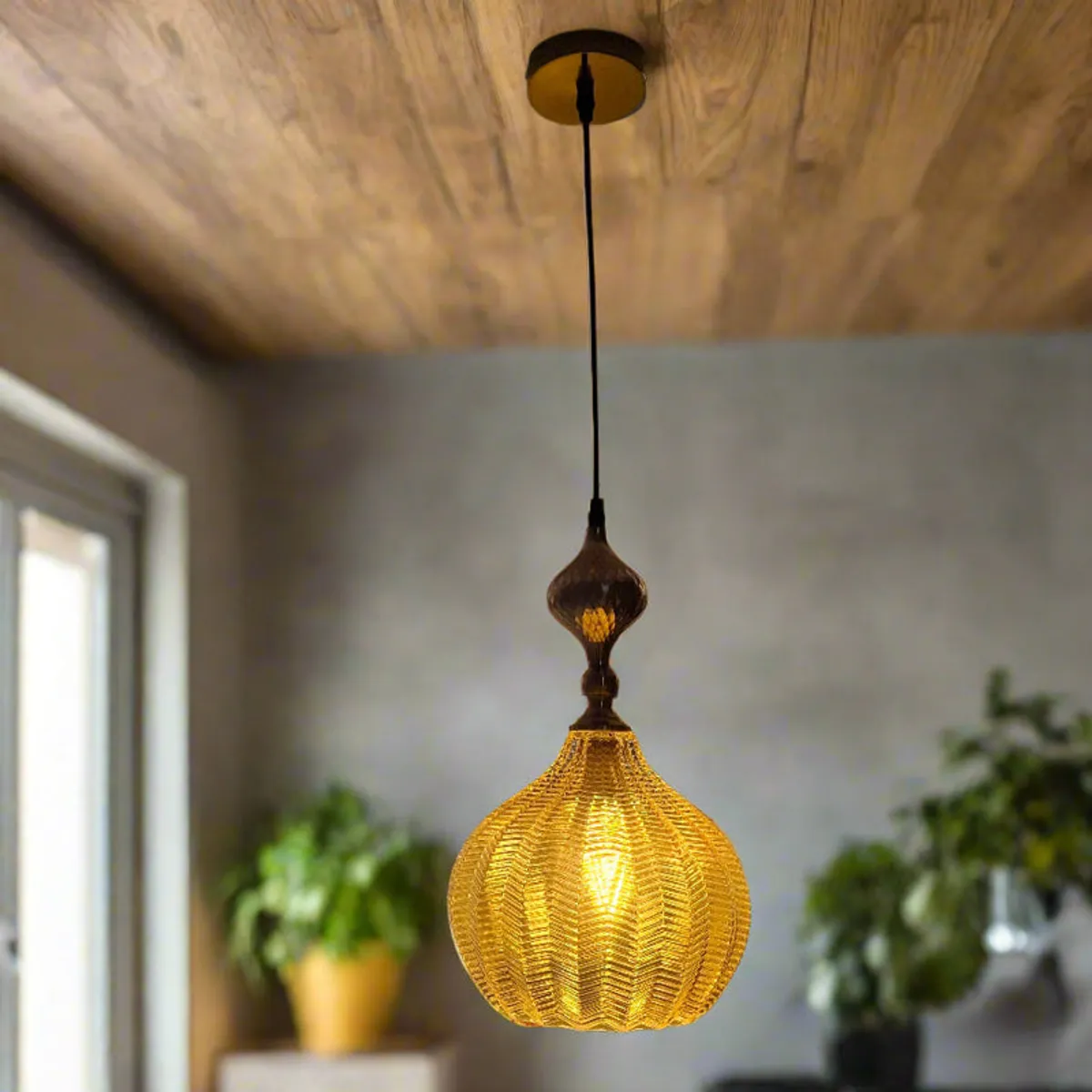 Lit gold pendant lamp in a softly styled interior